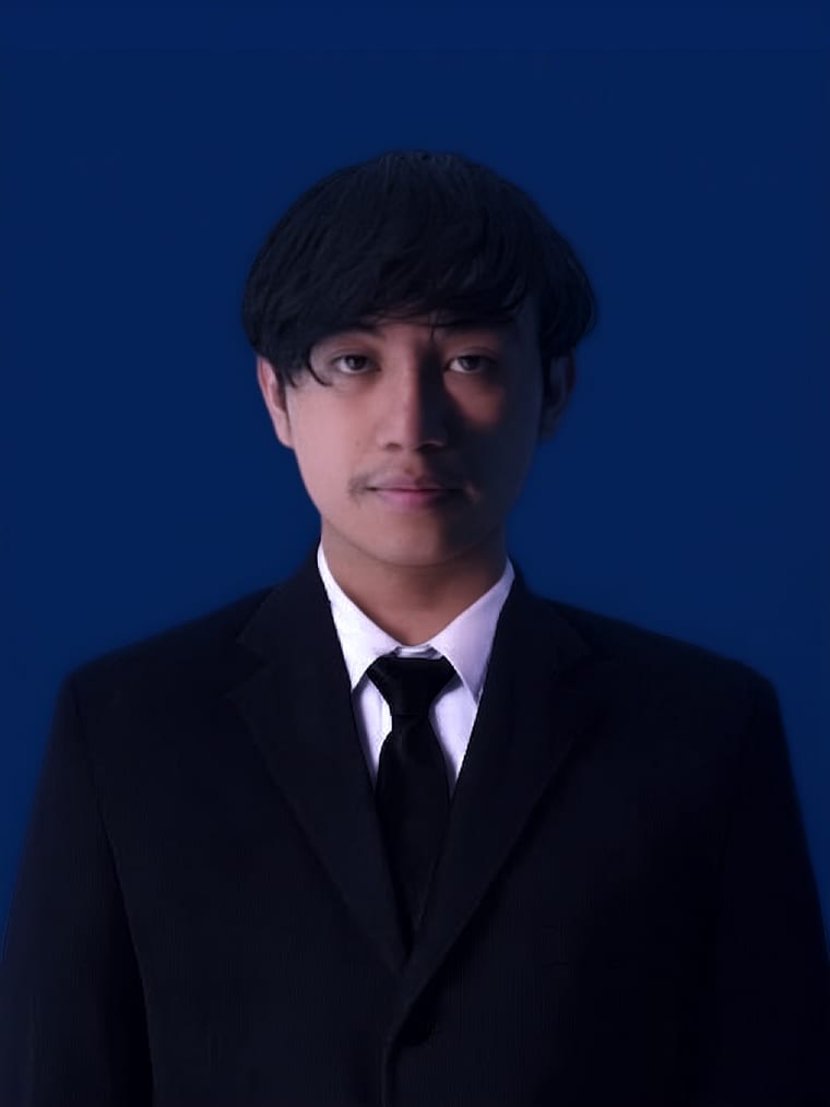 Portrait of Winayagatar in a dark suit.